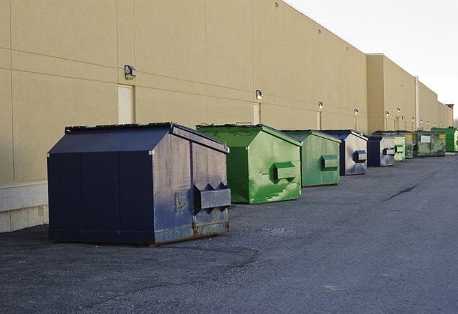 a row of construction dumpsters parked on a jobsite in Basom, NY